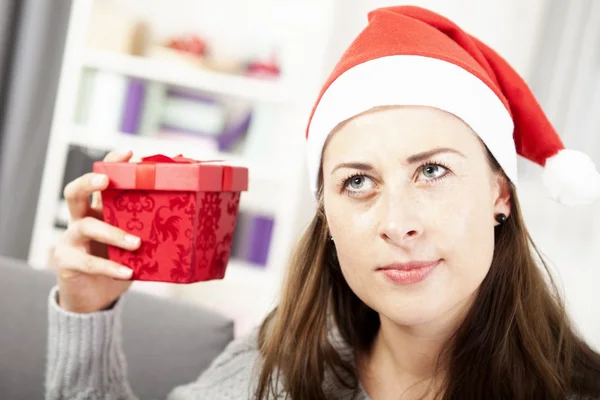 Young girl want to guess christmas gift — Stock Photo, Image