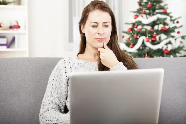 Young girl surfing with laptop at christmas — Stock Photo, Image