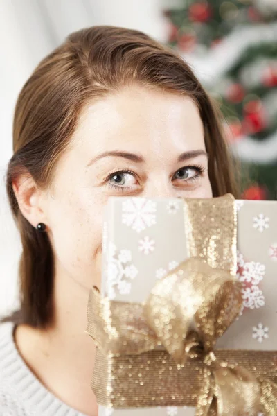 Girl hide behind christmas present box — Stock Photo, Image