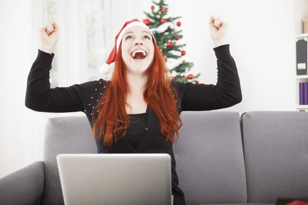 Girl with santa hat is raise arms into the air — Stock Photo, Image