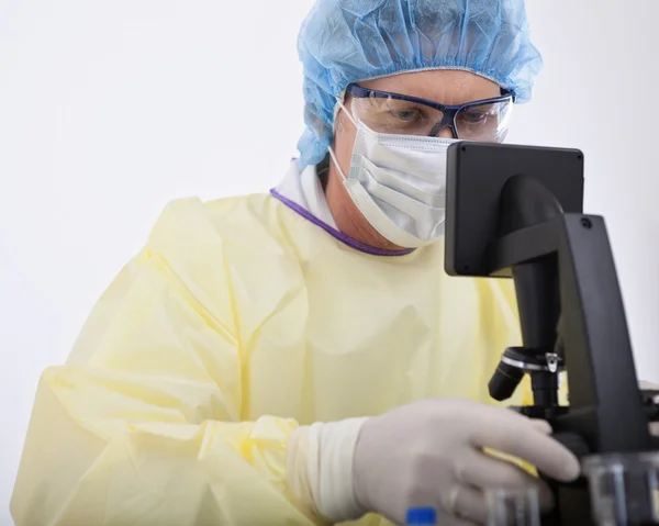 Doctor in protective gear holding blood sample — Stock Photo, Image