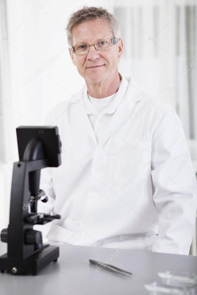 scientific researcher with microscope