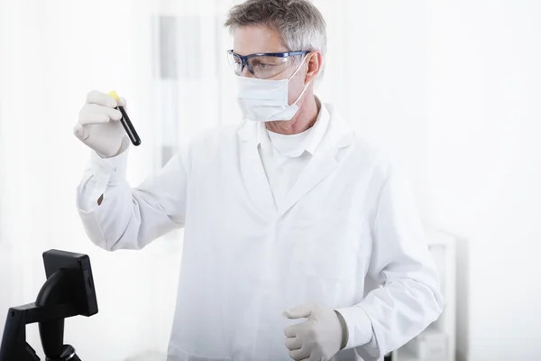 Doctor working with microscope and blood — Stock Photo, Image