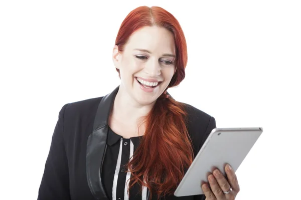 Redhead woman laughing as she reads her tablet — Stock Photo, Image