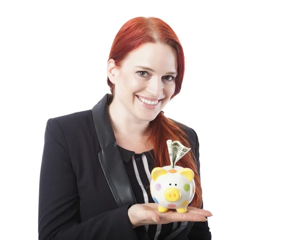 Pretty elegant redhead woman with a piggy bank — Stock Photo, Image