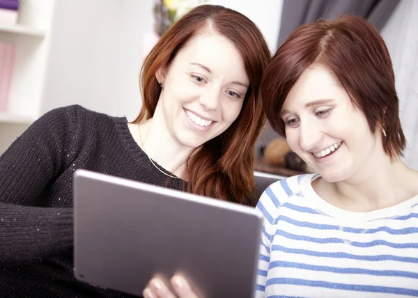 Two young girls with tablet computer — Stock Photo, Image