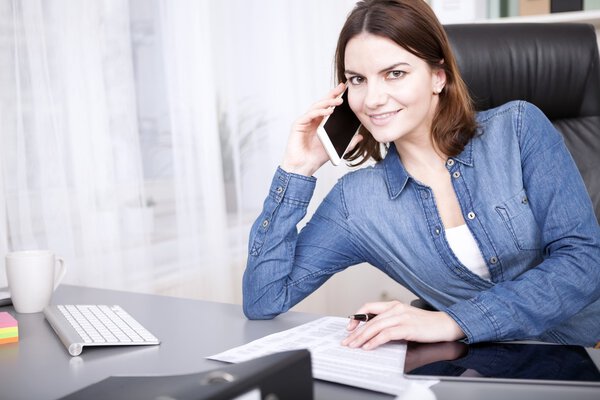 Friendly businesswoman smiling as she takes a call