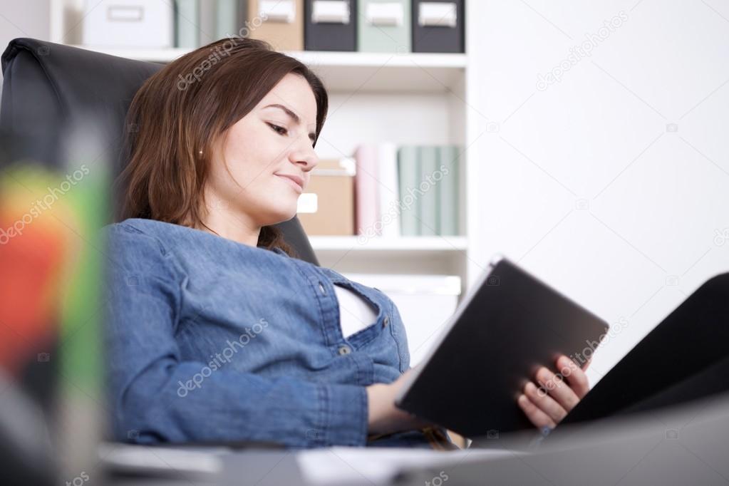 Office Woman Relaxing at her Chair with Tablet