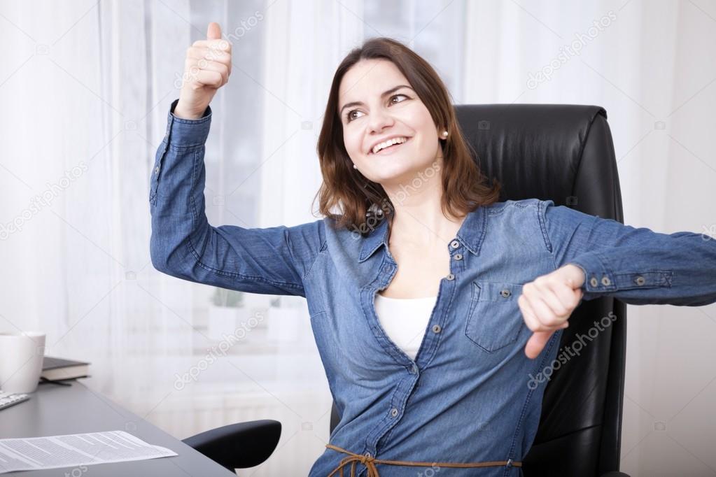 Undecided businesswoman doing a thumbs up and down