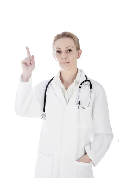 Mujer Doctor señalando hacia arriba y mirando a la cámara — Foto de Stock