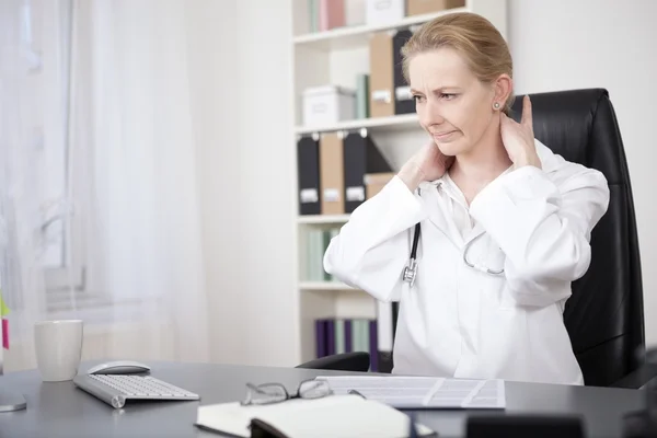 Tired Doctor Massaging the Back of her Neck — Stock Photo, Image