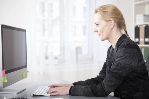 Happy Businesswoman en vue latérale attachement sur l'ordinateur — Photo