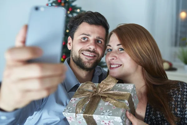 Happy couple is taking a selfie with gift — Stock Photo, Image