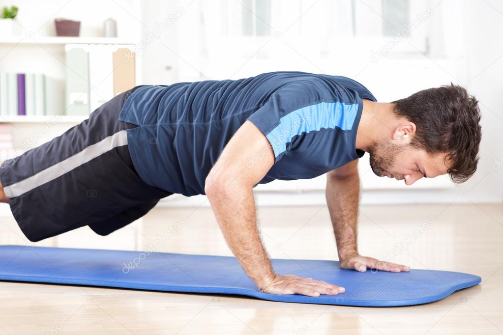 Side View of an Athletic Man Doing Push Ups