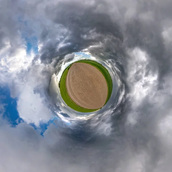 tiny planet transformation of spherical panorama 360 degrees. Spherical abstract aerial view on road with blue sky and awesome beautiful clouds. Curvature of space.