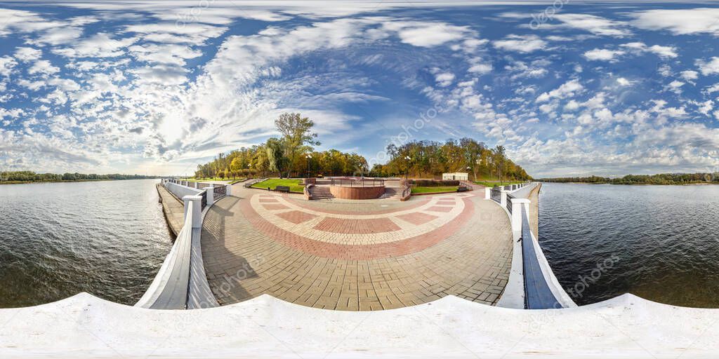 full seamless spherical hdri panorama 360 degrees angle view concrete embankment of wide river in sunny day with beautiful clouds in equirectangular projection, ready VR AR virtual reality content