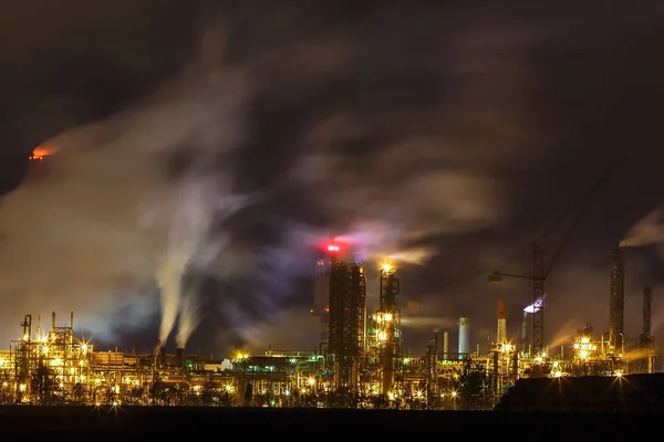 night industrial landscape environmental pollution waste of thermal power plant. Big pipes of chemical industry enterprise plant