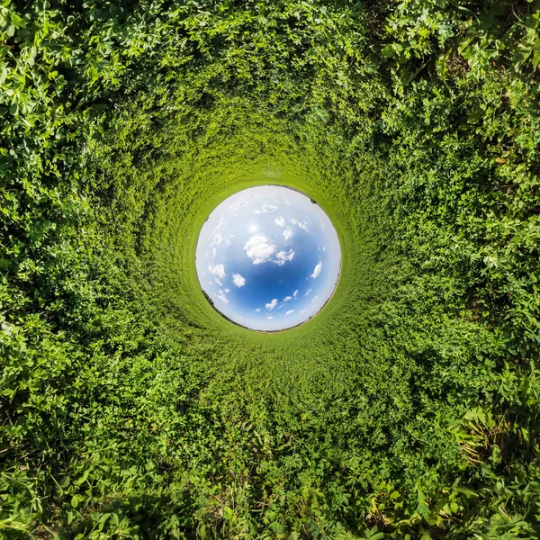 Blue little planet. Inversion of tiny planet transformation of spherical panorama 360 degrees. Spherical abstract aerial view. Curvature of space.