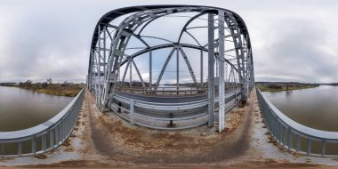 full seamless spherical hdri panorama 360 degrees angle view on steel frame construction of huge bridge across river in cloudy weather in equirectangular projection. VR  AR content clipart
