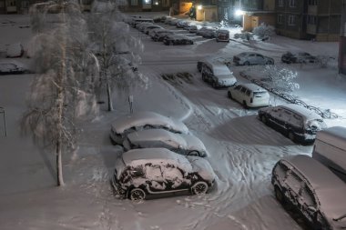 snow-covered overnight parking in the courtyard of a multi-storey area  clipart