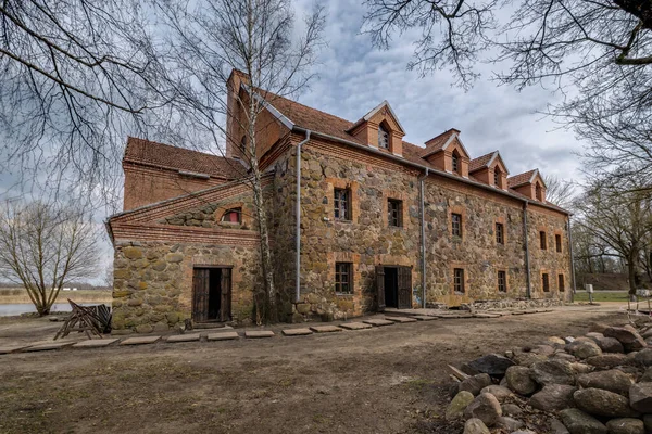 the building of the restored old stone mill in early spring