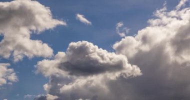 Time lapse clip of several fluffy curly rolling cloud layers in windy weather at overcast sky