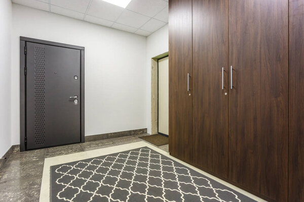 empty corridor for room in interior of modern apartments, office or clinic with many metal doors