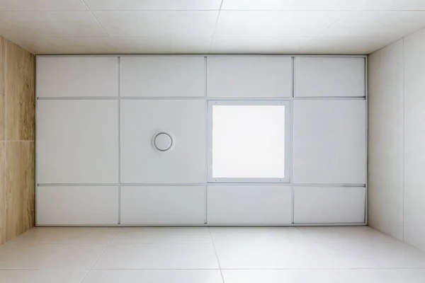 cassette suspended ceiling with square halogen spots lamps and drywall construction in empty room in apartment, clinic, office or house. Stretch ceiling white and complex shape. Looking up view