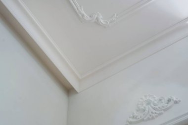 Köşedeki tavan ve duvarların ayrıntıları ve karmaşık taç kalıpları.