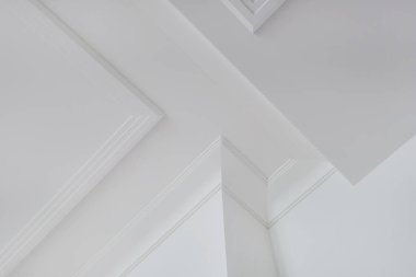 Köşedeki tavan ve duvarların ayrıntıları. Karmaşık taç kalıplarıyla. İç yapı ve yenileme konsepti.