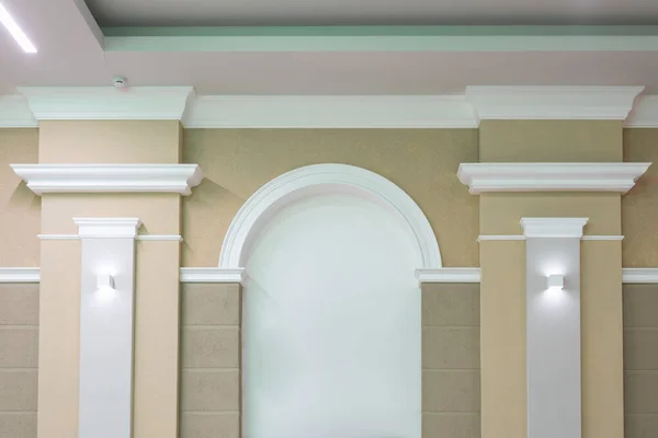 Detail of corner ceiling with intricate crown molding on column with spot light