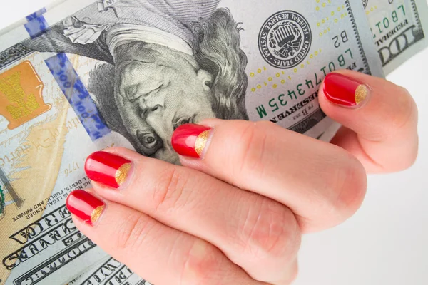 Girl with red manicure gives money. denominations hundred dollars — Stock Photo, Image