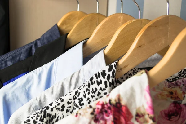 Different clothes on hangers close up — Stock Photo, Image