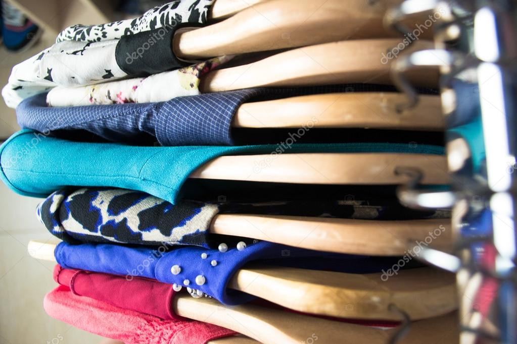 Different clothes on hangers close up