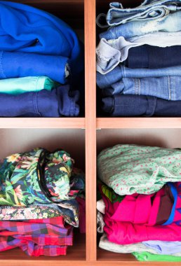 Clothes neatly folded on shelves