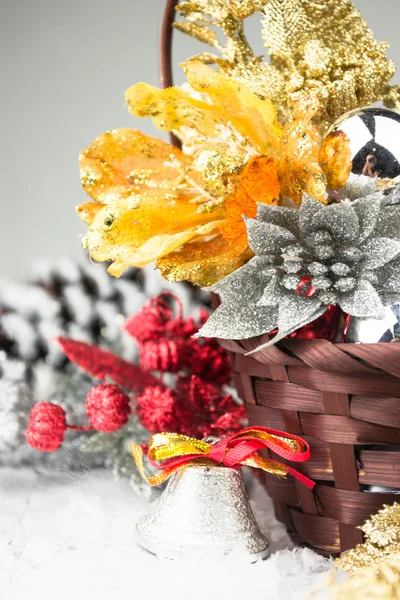 Brown Christmas basket with silver and gold toys on a white wooden background — Stock Photo, Image