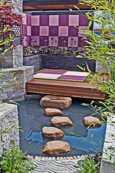 A tranquil Japanese retreat with water feature, decking and seating
