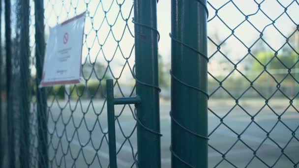 Prohibited enter sign on metal fence of playground during coronavirus pandemic. — Stock Video