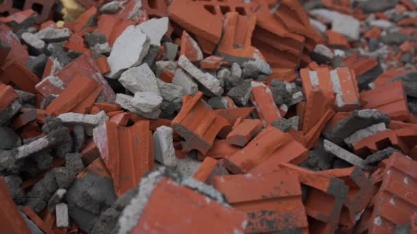 Heap of orange brick debris with remnants of concrete — Stock Video