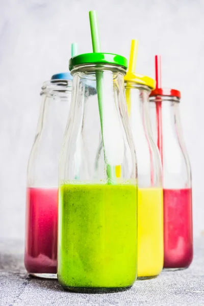 Colorful smoothies in bottles — Stock Photo, Image
