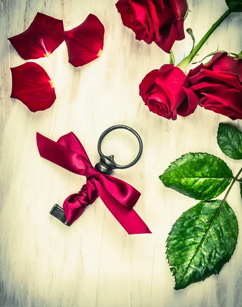 Antic key with ribbon and roses, retro love card, toned — Stock Photo, Image