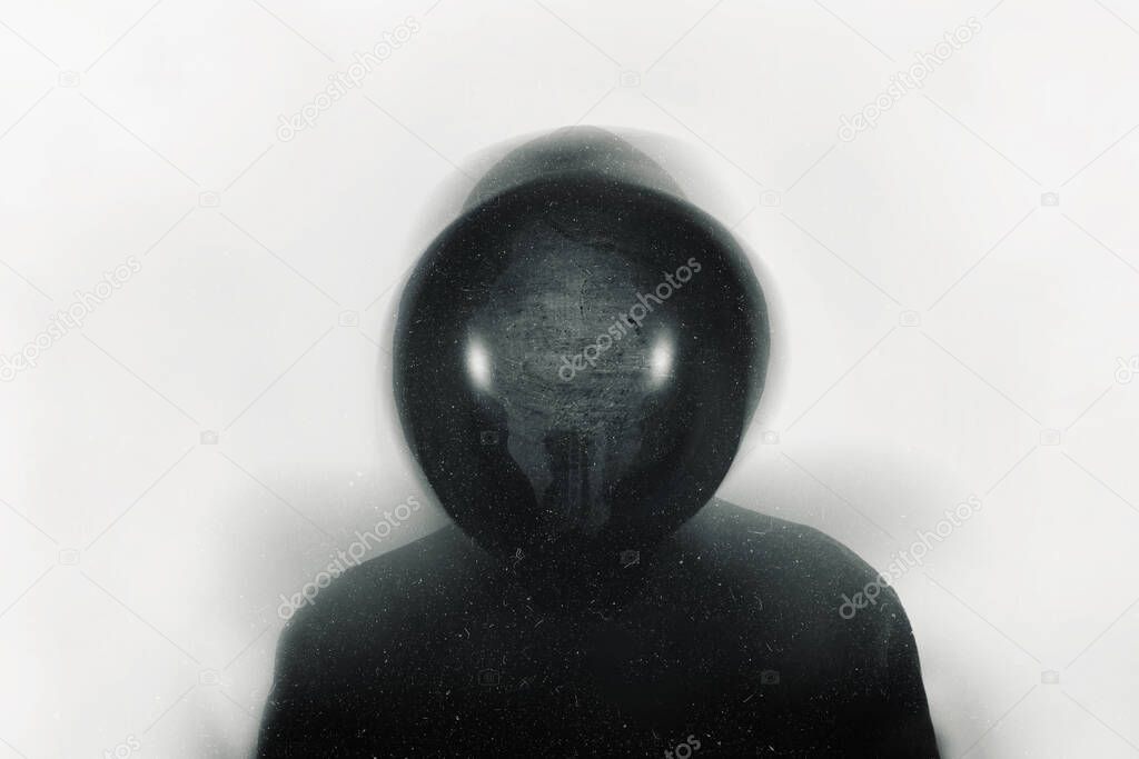 A scary hooded figure with an animal skull as a face looking at the camera. With a blurred, grunge, abstract edit           
