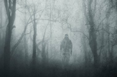 A dark scary concept. Of a mysterious supernatural figure, walking through a forest. Silhouetted against trees. On a foggy winters day. With a grunge, textured edit. 