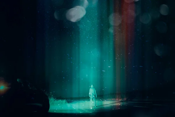 A mysterious UFO concept. Of a man next to a car, standing in the middle of a road looking up at the night sky. As a glowing beam of light comes down from the sky. With a retro, grunge edit.