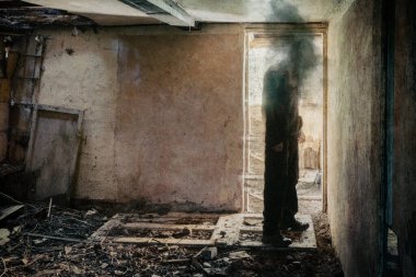 A horror concept. Of a figure with no face standing in the doorway of a decaying room in an abandoned ruined house