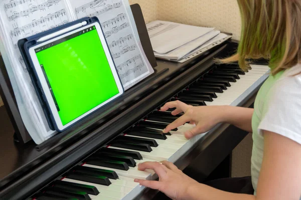 Scene of piano lessons online training or E-class learning while Coronavirus spread out or covid-19 crisis situation, vlog or teacher make online piano lesson to teach students pupils learn from home.