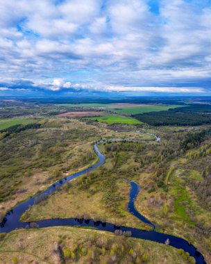 Spring river, Bend, forest and cloudy, cloudy sky.