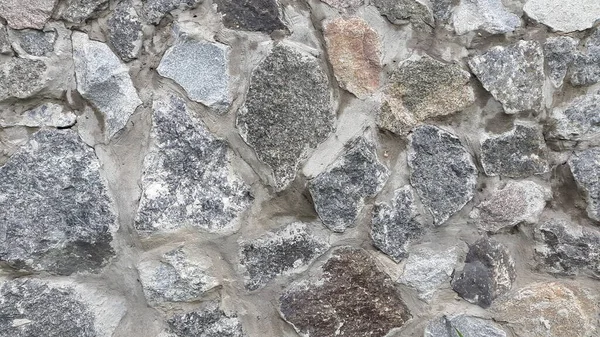 Granit duvar ustası. Granit taşlardan duvar. Eski arkaplan