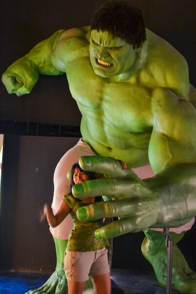 NEW YORK, CIRCA 2011 - Huge Hulk wax figure catches a girl in Madame Tussaud's museum in New York