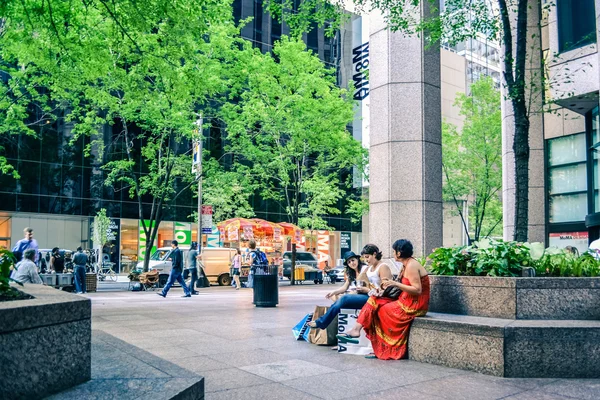 NUEVA YORK, EE.UU. - CIRCA 2011: la gente se sienta en el banquillo a las afueras del MoMA en Manhattan, Nueva York . — Foto de Stock